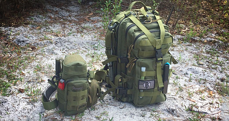 Maxpedition backpack on the ground with a bottle carrier