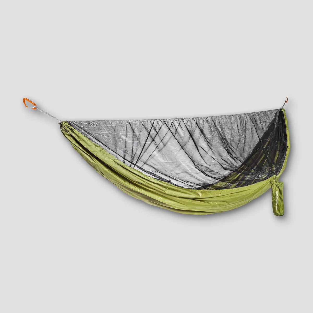 COCOON Ultralight Mosquito Net Hammock hung between two trees in a wooded setting