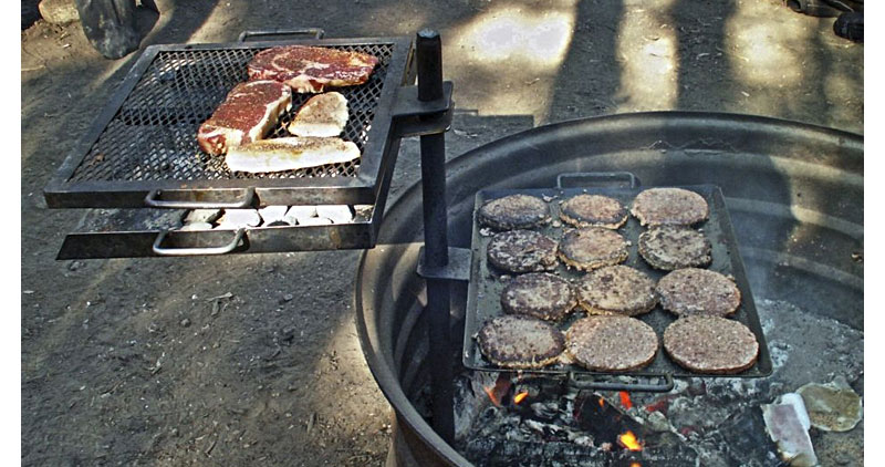 Stake style grill with hamburgers and steaks