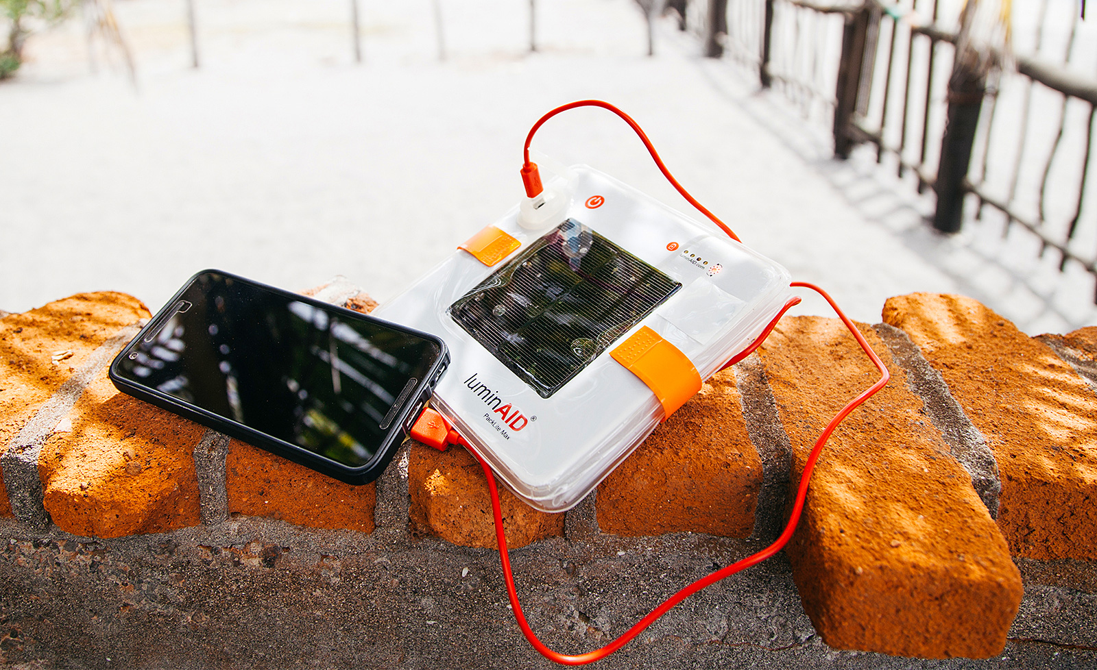 liminaid PackLite Max 2-in-1 Phone Charger with phone