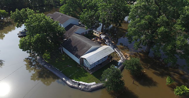 Prepare for floods with aquadam, shown surrounding a house