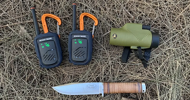Rockie Talkie Mountain Radio sitting next to a fallkniven knife on the forest floor