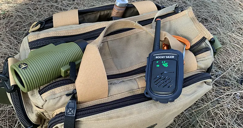 Rockie Talkie Mountain Radio sitting on top of a Maxpedition bag in the woods