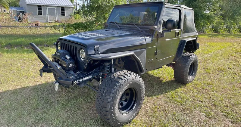Lifted Jeep Wrangler TJ with a winch bumper and off-road tires, a versatile bug out vehicle option