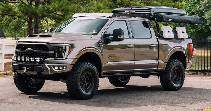 Ford F-150 Raptor off-road build with a rooftop tent and jerry cans, a powerful bug out vehicle choice