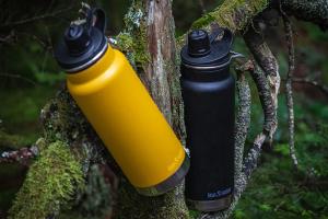 Klean Kanteen Bottles hanging on a tree in the woods