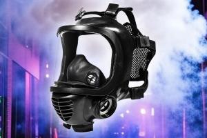 The Ultimate Gas Mask & Respirator Guide header image, a gas mask floating over smoke in the city at night