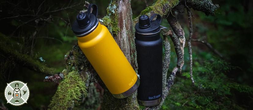 Klean Kanteen Bottles hanging on a tree in the woods