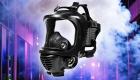 The Ultimate Gas Mask & Respirator Guide header image, a gas mask floating over smoke in the city at night