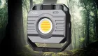A Fenix CL28R Lantern superimposed over an image of a forest
